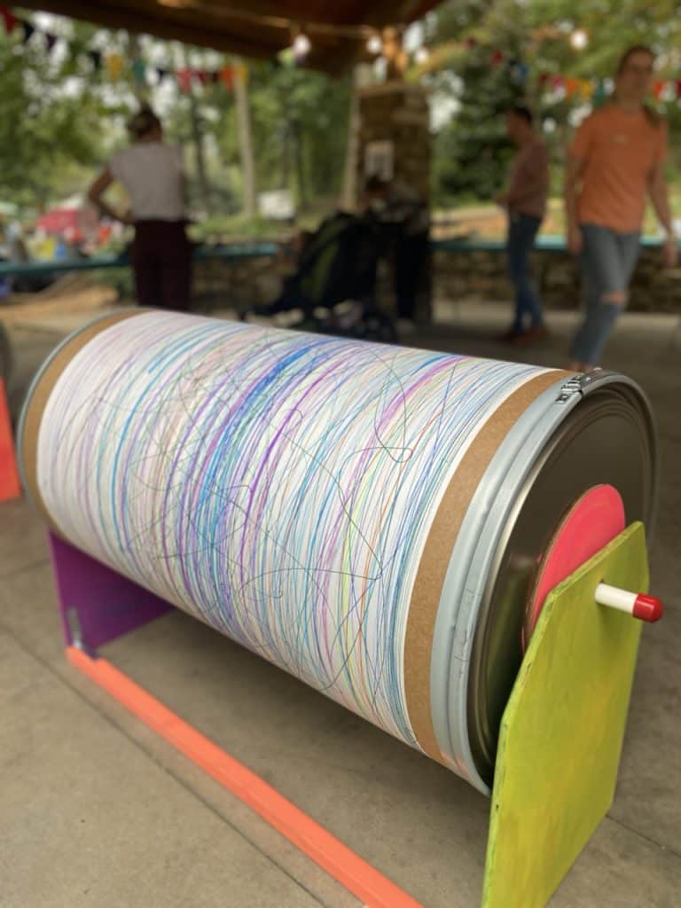 DIY giant spinning art barrel for kids made from a 55-gallon fiber drum